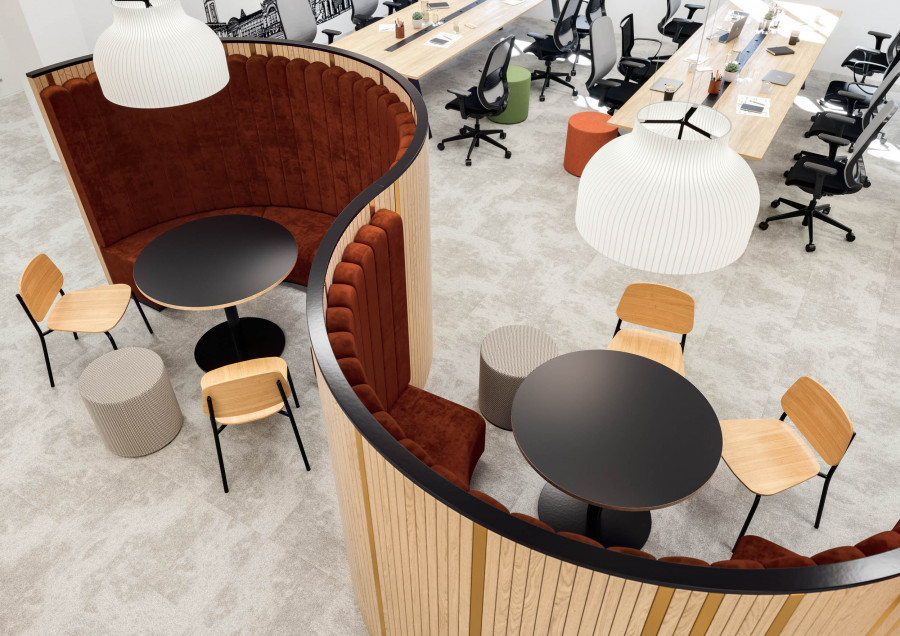 Overhead view of curved meeting pods with plush rust-toned seating and modern wooden paneling, showcasing a cozy and functional collaboration space.