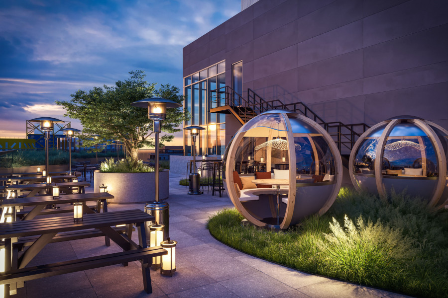 Visualization of an evening rooftop setting with dining pods, picnic benches, pathway lighting, and soft landscaping.