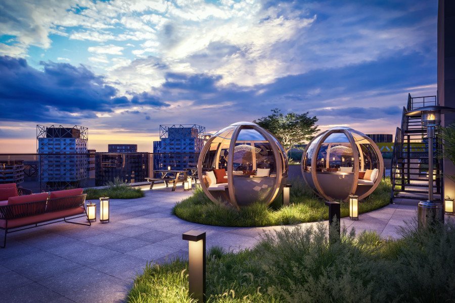 CGI of curved glass dining pods surrounded by planting and pathway lights during blue hour.