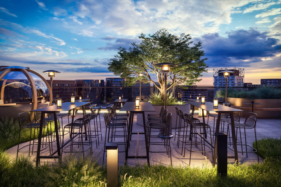 CGI of a rooftop terrace with high tables, bar stools, ambient lighting, and a tree overlooking the city at dusk.