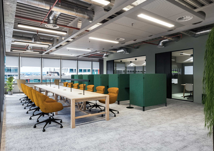 3D render of collaborative office area with green acoustic panels and long meeting table.